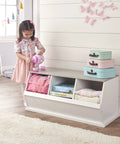 Child playing with a tea set next to a Three Bin Stackable Toy Storage Cubby Organizer For Kids Playroom And Bedroom Expandable Modular Toy Storage System For Toys And Crafts In White Gray Woodgrain, with toys inside.