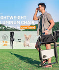 Man carrying Ultra Lite Aluminum Oversized Camping Chair With Side Table And Detachable Pocket outdoors, weighs 7.28 lbs