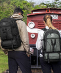 Two people with Expandable Hiking Backpack 40L To 50L For Men And Women Flight Approved Carry On Ready Travel Daypack near train
