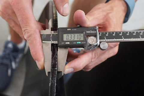 Caliper measuring replaceable cutting edge of Beefy 24 Inch Earth Auger With 2 Inch Round Drive And Replaceable Cutting Edges