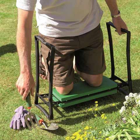 Person using Fold Away Garden Kneeler And Seat Dual Purpose With Sturdy Lightweight Steel Frame Folds Flat For Easy Storage EVA Foam Cushioned Pads Durable Powder Coated Finish Green on grass while gardening