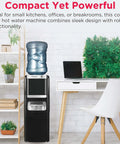 No Fuss Three In One Hot And Cold Water Cooler Dispenser Featuring Built In Bullet Ice Maker And Simple Top Load Five Gallon Bottle Compact Black Finish in kitchen setting.