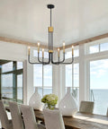 Six Light Black And Gold Farmhouse Chandelier For Dining Room And Kitchen Island hanging in a bright dining area