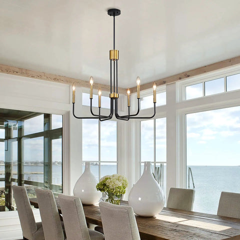 Six Light Black And Gold Farmhouse Chandelier For Dining Room And Kitchen Island hanging in a bright dining area