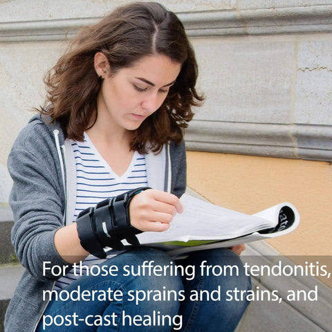 Person reading outdoors wearing wrist brace for right hand medium size 8 inch support adjustable straps all day comfy stable