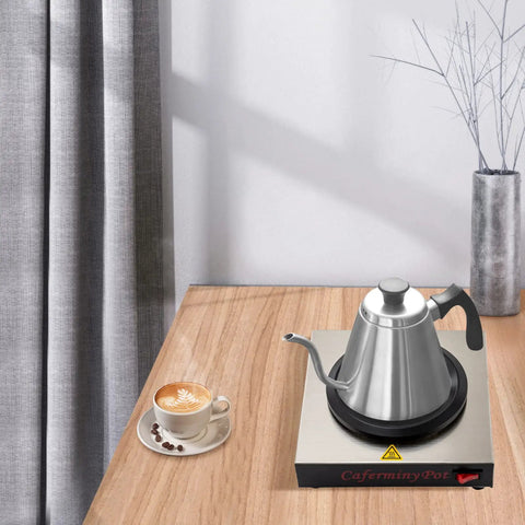 Commercial Stainless Steel Single Cup Warmer With 80W Heating Plate Keeps Your Daily Brew Hot All Day Long Non Stick Surface That Honestly Hits Different For Home Office Or Cafe Use on a wooden table with a coffee cup.
