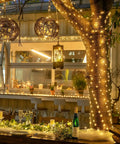 Outdoor patio wrapped in Two Pack Battery Operated Fairy Lights With Remote, 400 LEDs Spanning 132 Feet Of Warm White Twinkle Copper Wire