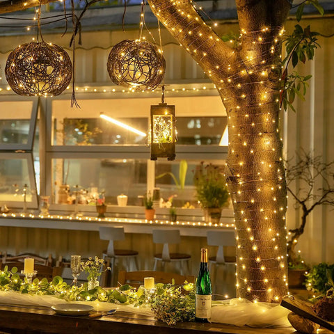 Outdoor patio wrapped in Two Pack Battery Operated Fairy Lights With Remote, 400 LEDs Spanning 132 Feet Of Warm White Twinkle Copper Wire