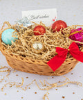 Gift basket with brown crinkle cut paper shred filler and festive ornaments, showcasing crinkle cut paper shred filler for gift baskets and boxes.