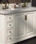 White bathroom vanity with Six Pack Antique Brass Finger Pulls for Cabinets and Drawers, solid zinc alloy hardware, vintage style handles.