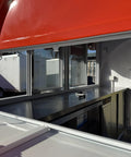 Inside view of Fully Custom Mobile Food Trailer Concession Rig with stainless steel counter and windows for vendors.