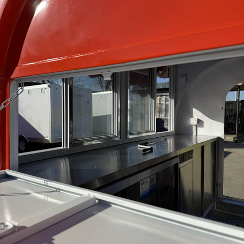 Inside view of Fully Custom Mobile Food Trailer Concession Rig with stainless steel counter and windows for vendors.
