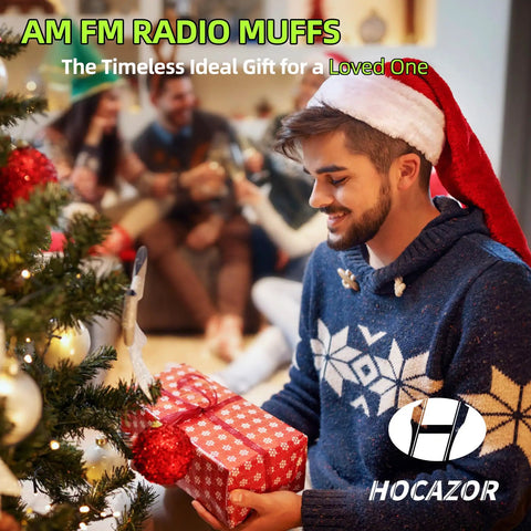 Man in festive attire with gift near Christmas tree, holding Bluetooth 5.4 Hearing Protection Headphones With AM FM Radio, 25dB NRR Earmuffs.