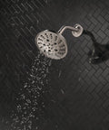 H2Okinetic Rain Shower Head With Five Settings In Stainless Finish Touch Clean Nozzle System spraying water in bathroom