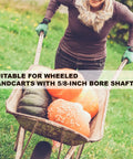 Person pushing a wheelbarrow with pumpkins, showcasing Heavy Duty Wheelbarrow Axle Bracket Kit With Five Eighth Inch Hole.