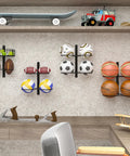 Wall Mounted Basketball Rack And Football Holder For Garage Sidekick, Adjustable Diy Soccer Stand With Basket, Hella Durable Black Metal Game Ball Organizer Flipping Tight Clutter Into Smooth Storage Flow, showcasing stored balls and sports gear on wall.