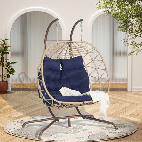 Double Swing Egg Chair With Stand For Patio And Balcony, Two Person Cozy Rattan Wicker Hanging Basket Chair With UV Cushions, in a room.
