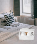 Premium Collapsible Oxford Cloth Drawer Organizer With Lid For Underwear Bras And Bathing Suits on a bed with white linens.