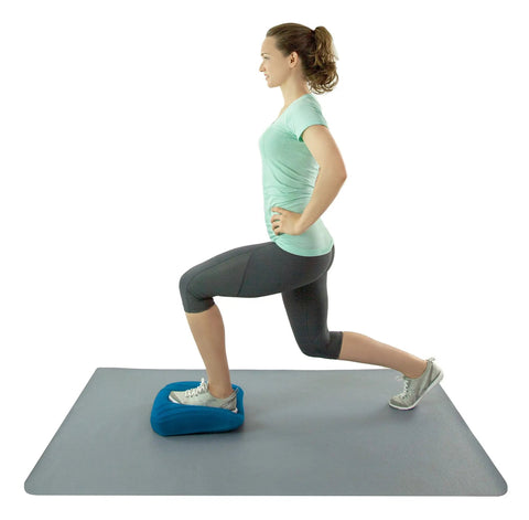 Teeter Core Restore Inflatable Lumbar Support Cushion For Back Pain Relief And Posture Correction used during a lunge exercise on a mat.