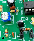 Close-up of a circuit board with Resistor Assortment Kit With 1400 Carbon Film Resistors, 140 Values, for DIY electronics.