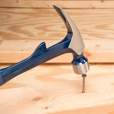 Hammertooth Hammer 22 oz USA Made Straight Rip Claw Hammer With Milled Face And Shock Reduction Grip shown driving a nail into wood