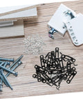 30 Pack Of Concealed Furniture Connector Brackets And Heavy Duty Metal Clamps For Bulletproof Cabinet Setup Tight Seal No Loose Ends, black metal fasteners laid on wooden surface.