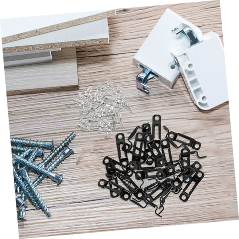 30 Pack Of Concealed Furniture Connector Brackets And Heavy Duty Metal Clamps For Bulletproof Cabinet Setup Tight Seal No Loose Ends, black metal fasteners laid on wooden surface.