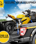 Yellow motorcycle secured with Beefed Up Heavy Duty Ratchet Straps 4 Pack 15 Ft Each 2200 Lb Break Strength With Safety Lock S Hooks