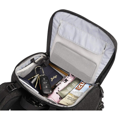 Inside view of Urban Access 13 Side Loading Camera Backpack with compartments, mesh pocket, and packed with personal items and keys.