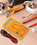 830D Digital Multimeter Tester with Buzzer 1999 Counts on wooden table with tools for electronics and automotive use.