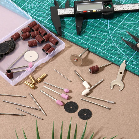 Heavy Duty 69 Piece Rotary Tool Accessories Kit With Rock Solid Sanding And Grinding Bits For Universal Shanks arranged on a work surface.