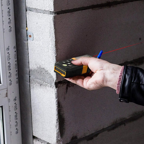 Laser Distance Measurer With 215 Ft Range, Diagonal Measuring Extension, And Mute Beep For Quiet Spaces, 100 Group Memory And Add Subtract Calculations, Ideal For Builders, Contractors, And DIYers measuring a cinder block wall