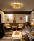 Retro BoHo Flush Mount Ceiling Fan With Open Caged Design And Integrated Warm Led Lighting illuminating a cozy living room.