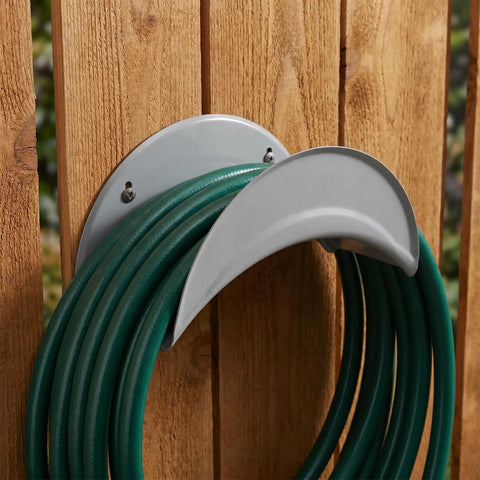 Heavy Duty Wall Mount Hose Hanger 2 Pack Sturdy Iron Metal Rack holding green hoses on wooden wall.