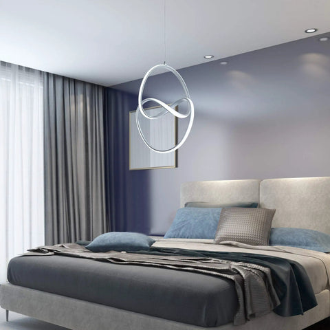 Lit Modern LED Pendant Light With Irregular Ring Design, 6000K Cool White hanging over modern bedroom, silver finish