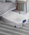 Two Pack 66 Quart Clear Underbed Storage Bins With Low Friction Wheels And Snap Tight Blue Latches under a bed, storing shoes.