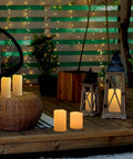 Waterproof Outdoor Flameless Pillar Candles 10x5 Inch Battery Operated LED With Remote And Timer Flickering Ivory White Pillar Candles on patio