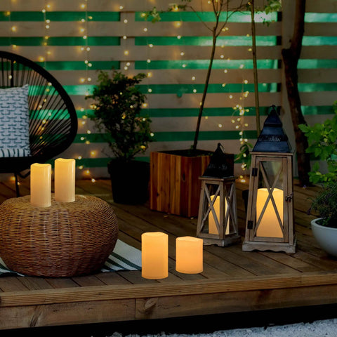 Waterproof Outdoor Flameless Pillar Candles 10x5 Inch Battery Operated LED With Remote And Timer Flickering Ivory White Pillar Candles on patio