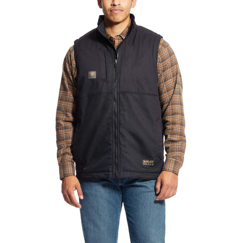 Man wearing Rugged DuraCanvas Work Vest With 9 Oz ToughMax DuraStretch, featuring black exterior and plaid shirt, standing pose