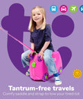 Child enjoying kids ride-on luggage, pink suitcase with wheels