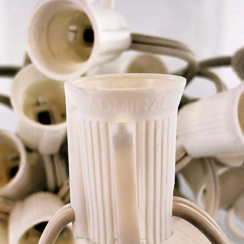Close-up of E17 sockets on white cord, part of C9 Light Strings For Outdoor Holiday Decor, 100 Foot White Cord With 12 Inch Socket Spacing.