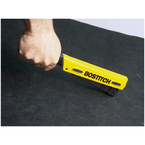 Yellow Heavy Duty Hammer Stapler For Light Wire Staples One Quarter Inch To Three Eighths Inch in use on black surface