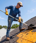 Man using Flex Grip Roof Cleanup Shovel With Segmented Adjustable Pole No Sweat Sweep for loose asphalt shingles.