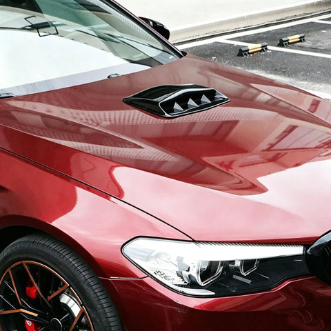 Premium Gloss Black ABS Plastic Hood Scoop Trim Built For Tesla Cybertruck installed on a red vehicle hood, showcasing sleek design.