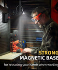 A man using the Boss Level Ultra Bright 2000 Lumen Magnetic Gooseneck Work Light on a workbench, highlighting its magnetic base.