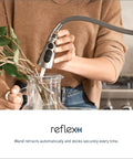 Woman using Spot Resist Stainless Single Handle Pull Out Sprayer Kitchen Faucet With Soap Dispenser And Power Clean in kitchen