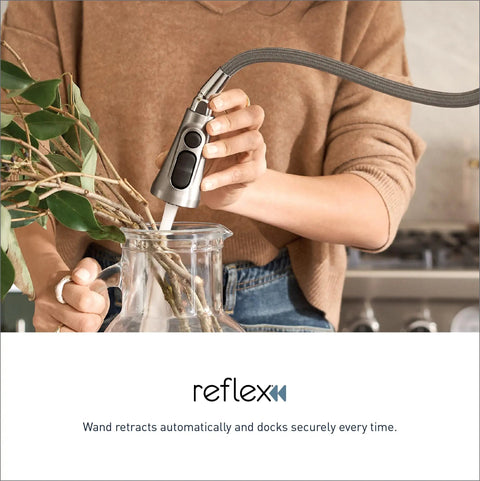 Woman using Spot Resist Stainless Single Handle Pull Out Sprayer Kitchen Faucet With Soap Dispenser And Power Clean in kitchen