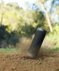 XB23 Portable Bluetooth Speaker With Beast Bass And Rugged Waterproof Design IP67 Dustproof Rustproof And Shockproof Up To 12 Hours Of Battery Life Lightweight Yet Powerful Ideal For Outdoors Poolside Beach And Travel shown ruggedly in outdoor dirt setting