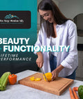 Wooden cutting board on kitchen counter; person cuts yellow bell pepper; Blue Ridge Mountain Gifts branding visible.