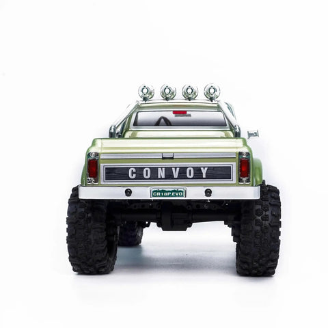 Badass 1/18 Scale RC Crawler With Slick Shifting Two Speed Transmission And Bulletproof Metal Gears Nasty Terrain Rock Climbing Rig Trail Smashin Setup Drop In Ready Convoy Medium Olive Green rear view with logo and lights.